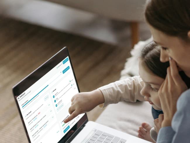 Parent and child looking at a laptop screen together
